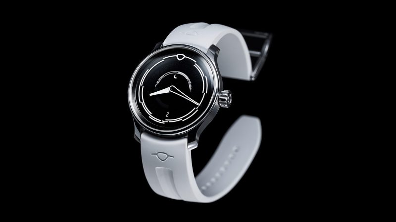 The MING 37.05 Lunatic watch has a sapphire dial, a luminous moonphase, a stainless steel 38mm case, and a white FKM rubber strap.