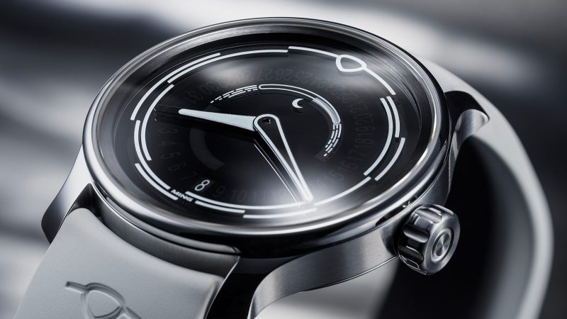 The MING 37.05 Lunatic watch has a sapphire dial, a luminous moonphase, a stainless steel 38mm case, and a white FKM rubber strap.