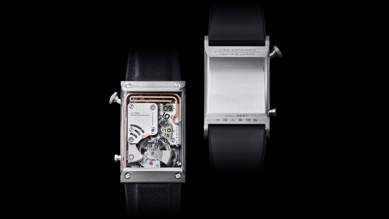 The OTSUKA LOTEC № 9 Free Wheel Maillechort luxury watch features a stainless steel case, a sapphire wrap-around crystal, a jumping hour disc, retrograde minutes, and an exposed tourbillon with chiming gong.