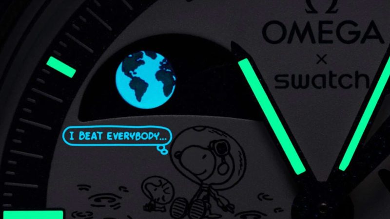 The Omega x Swatch Mission to Earthphase Moonshine Gold Corn Moon edition features a blue dial, Snoopy and Woodstock, and popcorn-box moon disc detail.