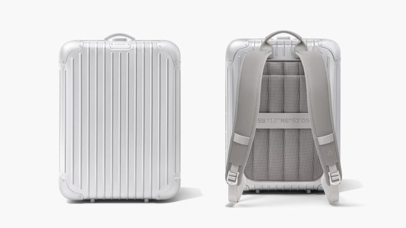 RIMOWA Original Backpack in silver anodized aluminum featuring a secure lock system, a laptop compartment, a removable pouch, and a suitcase sleeve.