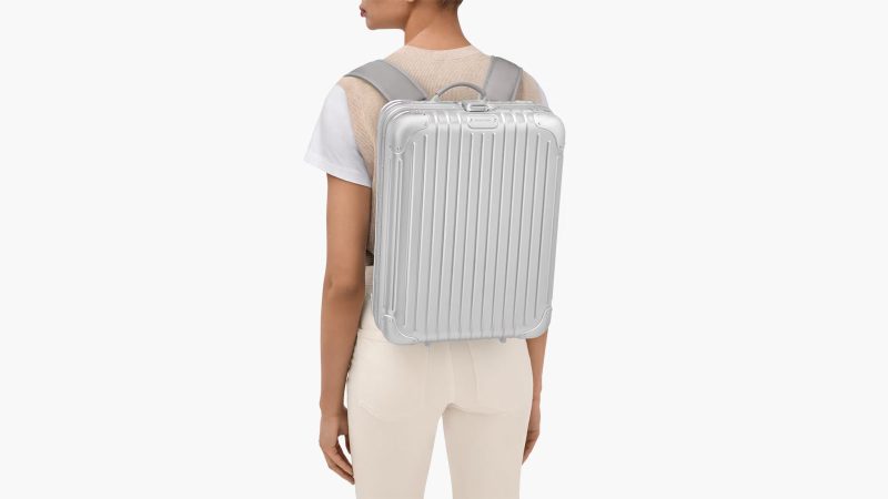 RIMOWA Original Backpack in silver anodized aluminum featuring a secure lock system, a laptop compartment, a removable pouch, and a suitcase sleeve.