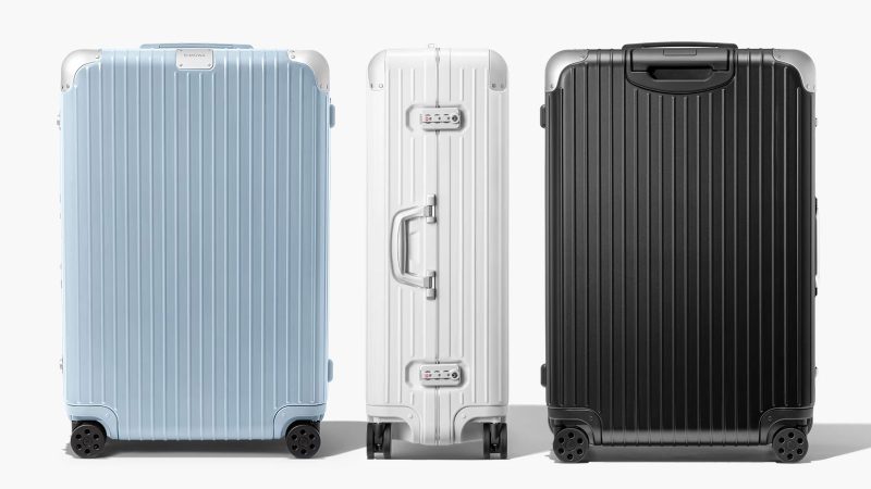RIMOWA Hybrid Suitcase Collection in Gloss Sky Blue, Gloss White, and Matte Black with aluminum corners and polycarbonate shell, designed for premium travel.
