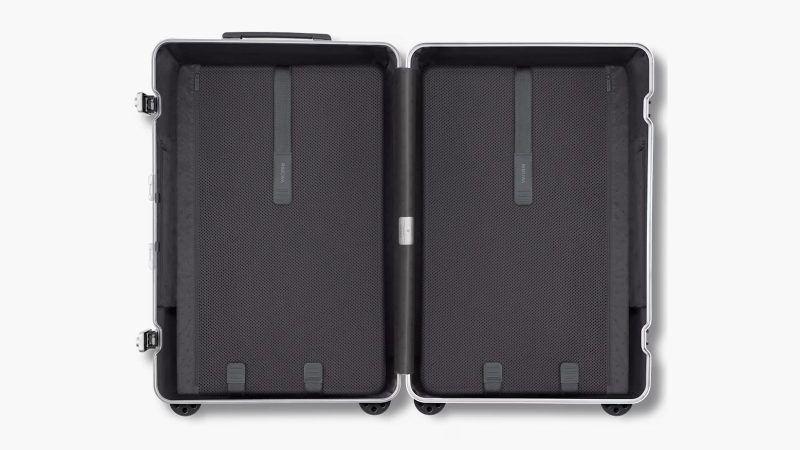 RIMOWA Hybrid Suitcase Collection in Gloss Sky Blue, Gloss White, and Matte Black with aluminum corners and polycarbonate shell, designed for premium travel.