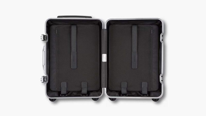RIMOWA Hybrid Suitcase Collection in Gloss Sky Blue, Gloss White, and Matte Black with aluminum corners and polycarbonate shell, designed for premium travel.