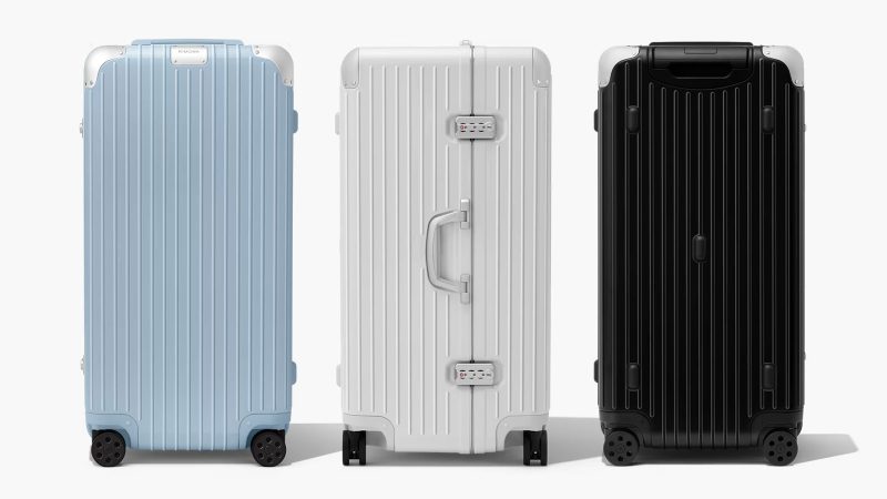 RIMOWA Hybrid Suitcase Collection in Gloss Sky Blue, Gloss White, and Matte Black with aluminum corners and polycarbonate shell, designed for premium travel.