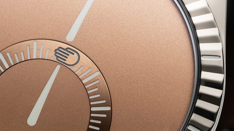 Ressence x The Armoury Type 9 ‘Scattering Sun’ watch with salmon dial, fluted bezel, and suede strap in limited edition release.