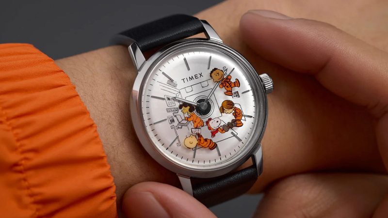 The Timex x Peanuts Marlin Automatic Space watch with Snoopy floating second hand, 40mm stainless-steel case, silver sunray dial, and eco-friendly leather strap.