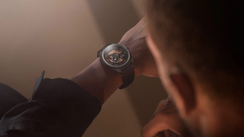 Ulysse Nardin Freak X Crystalium watch with black DLC titanium case, unique ruthenium crystal dial, and rose-gold accents on ballistic-textured strap.