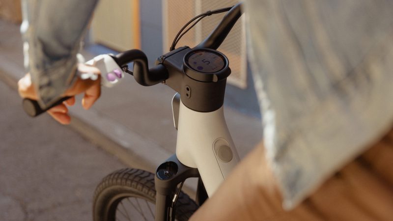 The Also TM-B Launch Edition e-bike in matte silver with a 5-inch digital display and a modular frame, designed by Rivian spinoff for next-gen commuting.
