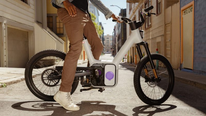 The Also TM-B Launch Edition e-bike in matte silver with a 5-inch digital display and a modular frame, designed by Rivian spinoff for next-gen commuting.