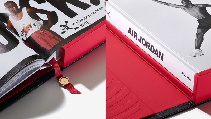 A deluxe edition book titled ‘Air Jordan: The Ultimate Collection’ by Assouline, encased in an ornate black leather clamshell box embossed with Baroque motifs, with a red ribbon and gold medallion bookmark visible.