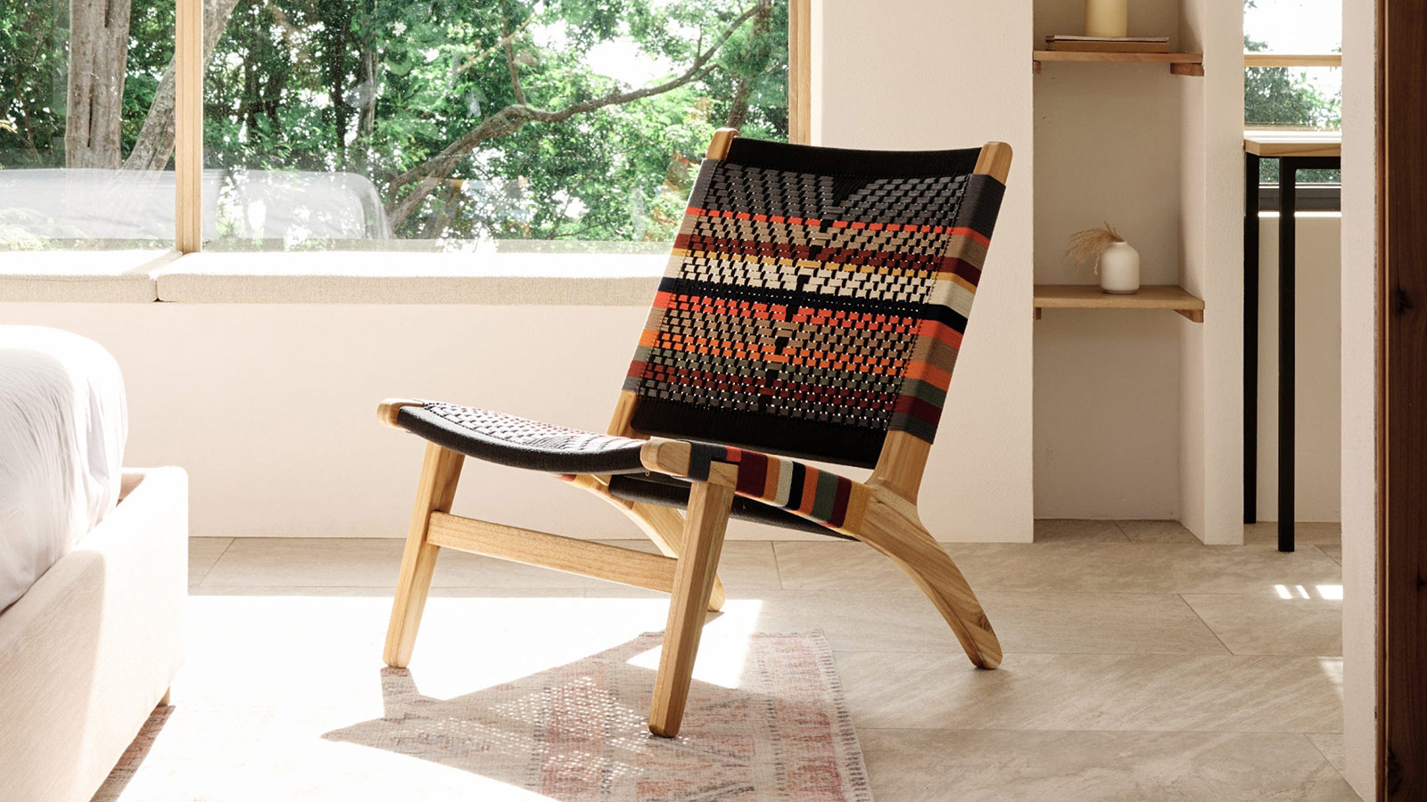 Masaya Lounge Chair in woven Serena pattern, a teak accent chair blending craftsmanship and comfort for men.