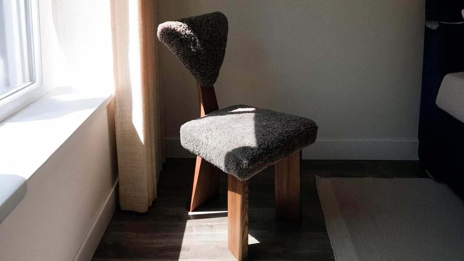 Eternity Modern Giraffe Sheepskin Chair with sculptural wood frame, a statement accent chair for men with bold taste.