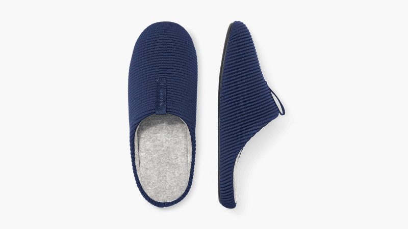 The Bombas Men’s Nest Slipper features a terry lining and cushioned sole on a white background.