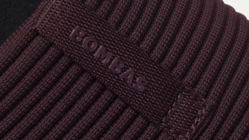 The Bombas Men’s Nest Slipper features a terry lining and cushioned sole on a white background.