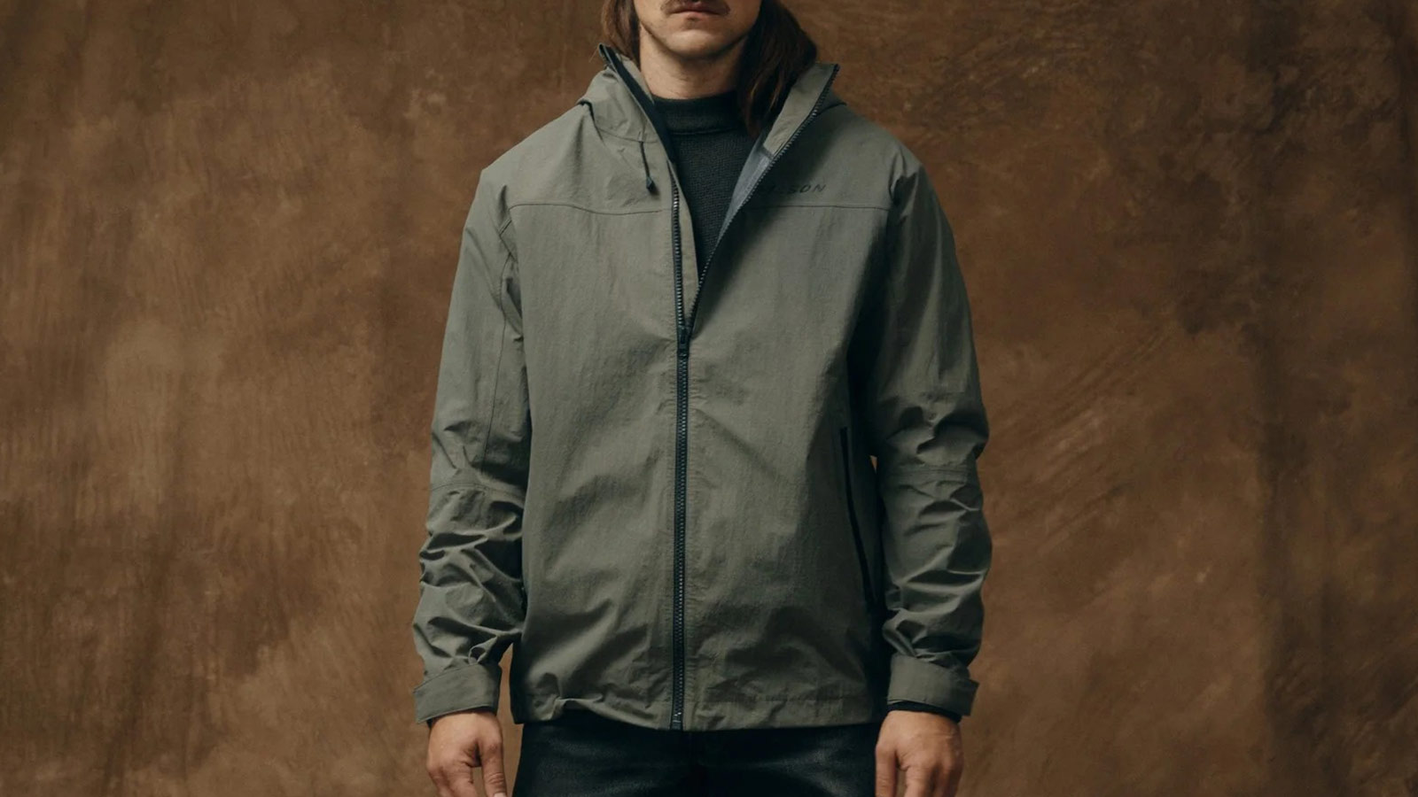 Lightweight olive green rain jacket for men, part of the best men’s fall trail-to-town gear