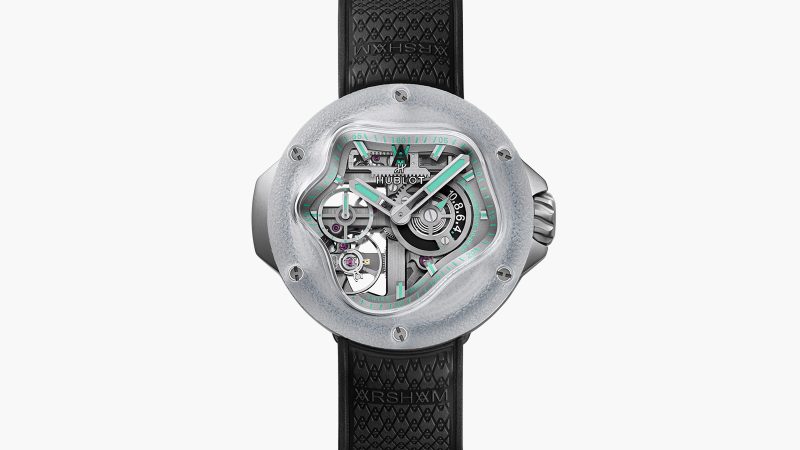 The Hublot MP-17 Meca-10 Arsham Splash Titanium Sapphire watch boasts a fluid design, green accents, and a transparent sapphire case, limited to 99 pieces.