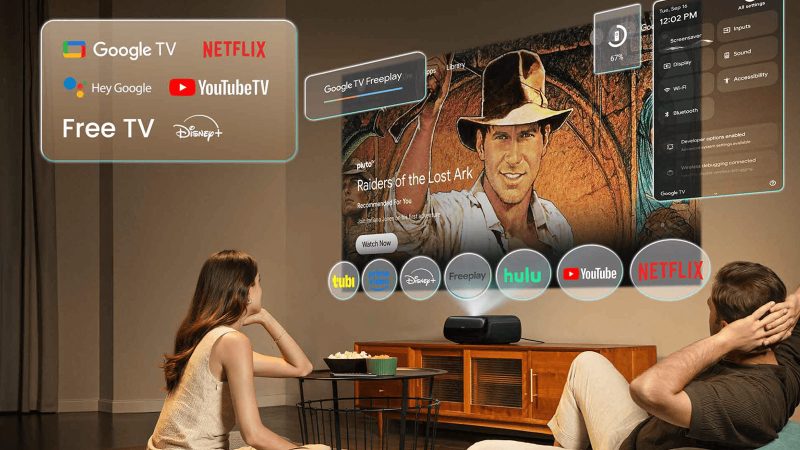 The JMGO O2S Ultra UST Projector in silver finish projecting a bright 100-inch 4K image with Google TV interface.