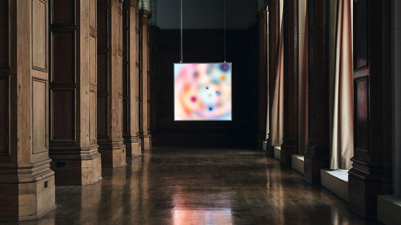 Layer Canvas ultra-high-resolution digital art display mounted in a minimalist living room, true black screen, and wide color gamut.