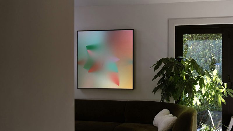 Layer Canvas ultra-high-resolution digital art display mounted in a minimalist living room, true black screen, and wide color gamut.