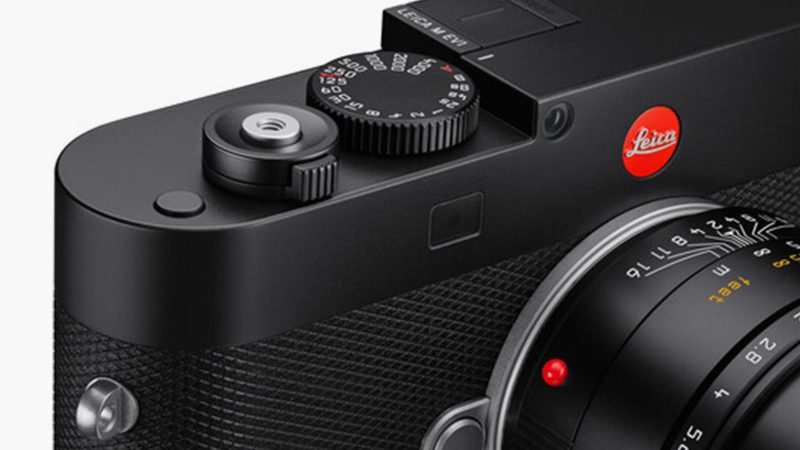 The Leica M EV1 full-frame digital camera in black metal, showing minimalist front panel without rangefinder window and 5.76-million-dot EVF.