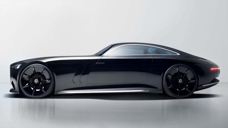 The Mercedes Vision Iconic concept EV features a long hood, solar panel surfaces, an illuminated grille, vintage coupe proportions, and futuristic detailing
