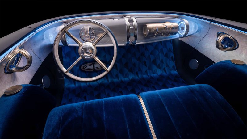The Mercedes Vision Iconic concept EV features a long hood, solar panel surfaces, an illuminated grille, vintage coupe proportions, and futuristic detailing