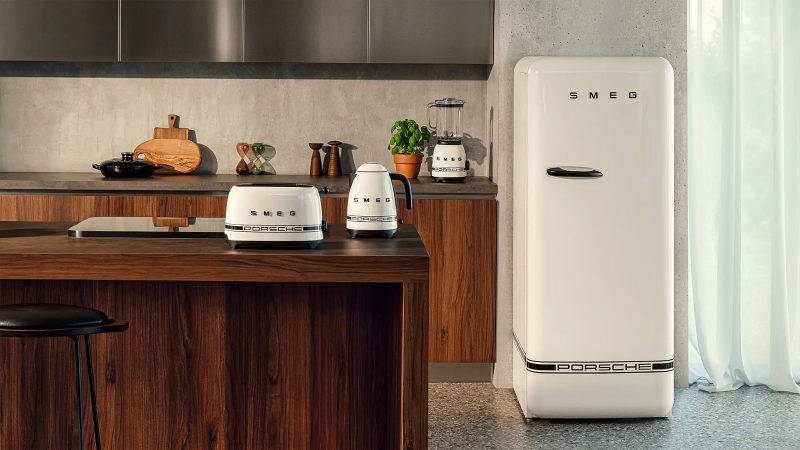 The limited-edition Porsche × Smeg appliances lineup boasts bold racing stripes—featuring a fridge and coffee machine in motorsport styling.