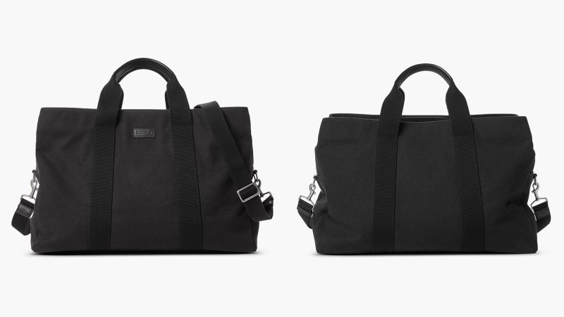 Shinola’s Runwell Canvas Duffle Bag in black canvas with leather trim, matte nickel hardware, and a TSA-approved carry-on design.