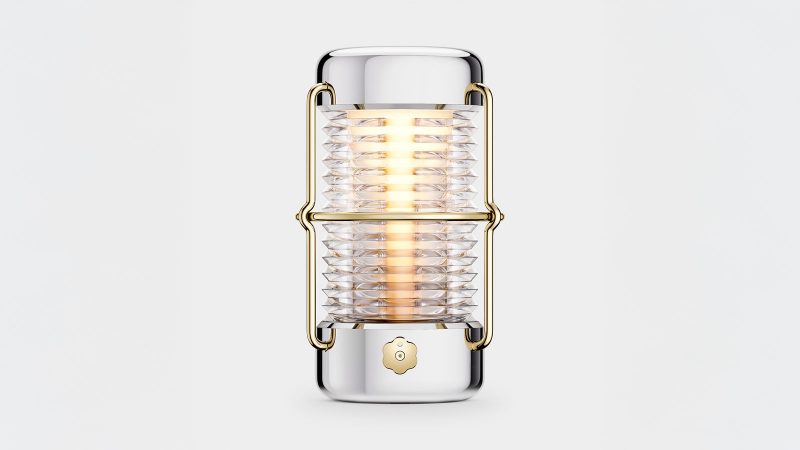 LoveFrom x BALMUDA Sailing Lantern in polished stainless steel with gold accents, suspended by a woven marine-grade lanyard.