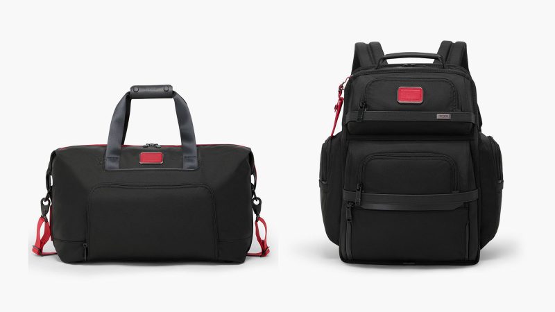 TUMI’s “Gift Joy” campaign features classic TUMI Red and Black luggage pieces—including the 19 Degree Aluminum Carry-On and Celina Backpack—stacked and tied with a festive red ribbon.
