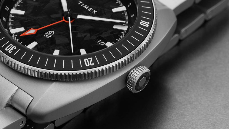 The James Brand × Timex Automatic GMT Nocturne Edition watch with carbon fiber dial, stainless-steel case, and ceramic bezel.