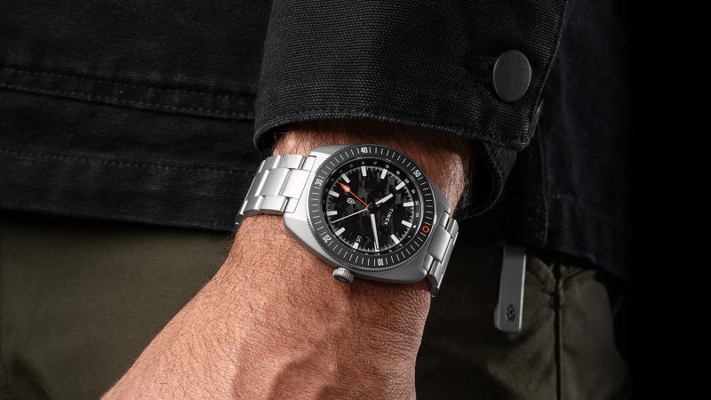 The James Brand × Timex Automatic GMT Nocturne Edition watch with carbon fiber dial, stainless-steel case, and ceramic bezel.