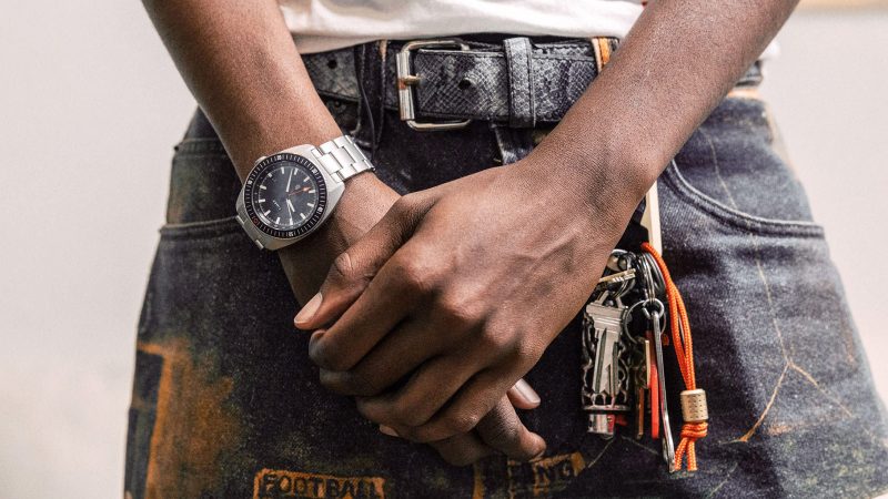 The James Brand × Timex Automatic GMT Nocturne Edition watch with carbon fiber dial, stainless-steel case, and ceramic bezel.