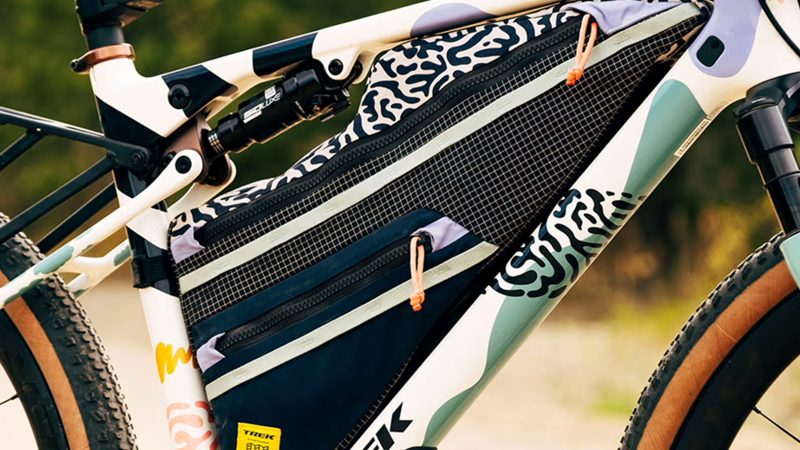 Trek x Topo Designs Project One ICON Checkmate Gravel Bike, featuring bold patterns and rugged outdoor performance, with bags.