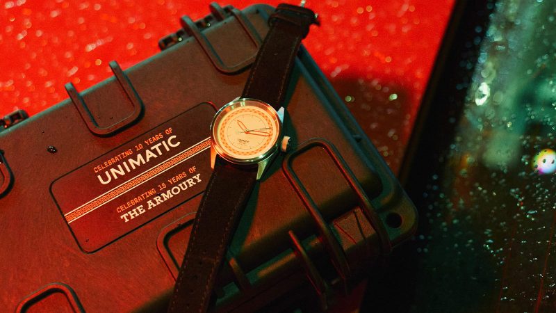 Unimatic x The Armoury Modello Cinque U5S-TA2 “10.15” watch with red and white dial accents, black hour ring, and red TPU strap.