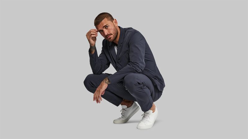 The Vollebak Neo Suit in black Cordura features four-way stretch, water repellence, and minimalist design with hidden zippers and articulated tailoring.