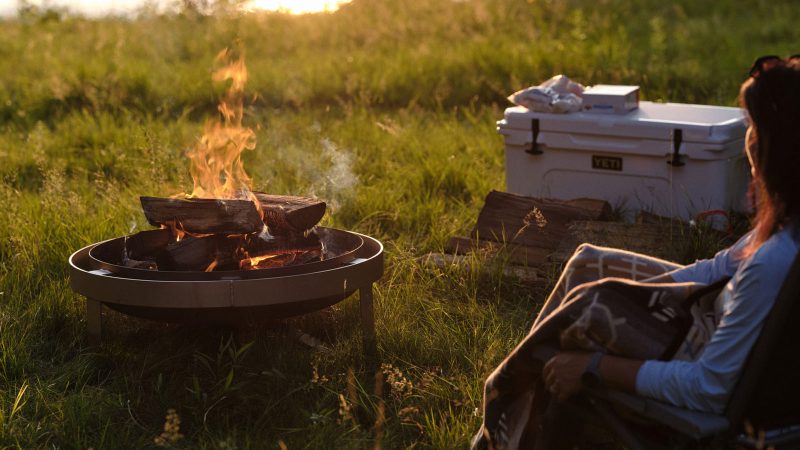 The YETI Fire Pit boasts a durable stainless steel design and an advanced airflow system, perfect for outdoor gatherings and cooking.