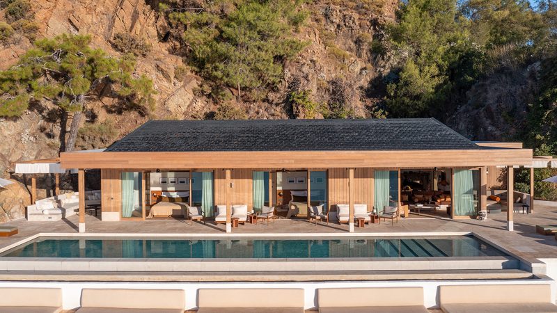 Luxury eco-designed beachfront cabana at Ahãma in Fethiye, Turkey, surrounded by forest and Aegean coastline.