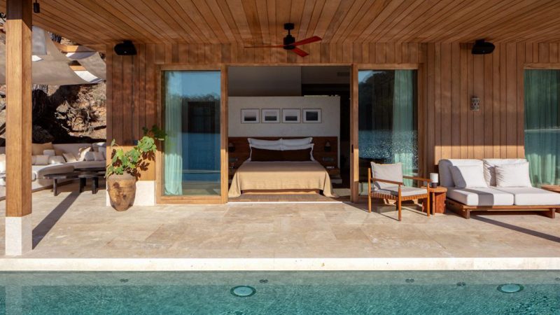 Luxury eco-designed beachfront cabana at Ahãma in Fethiye, Turkey, surrounded by forest and Aegean coastline.