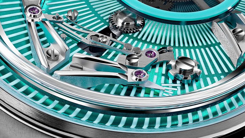 Christopher Ward’s C1 Bel Canto Lumière glowing titanium watch with luminous dial, blue accents, and white Super-LumiNova strap.