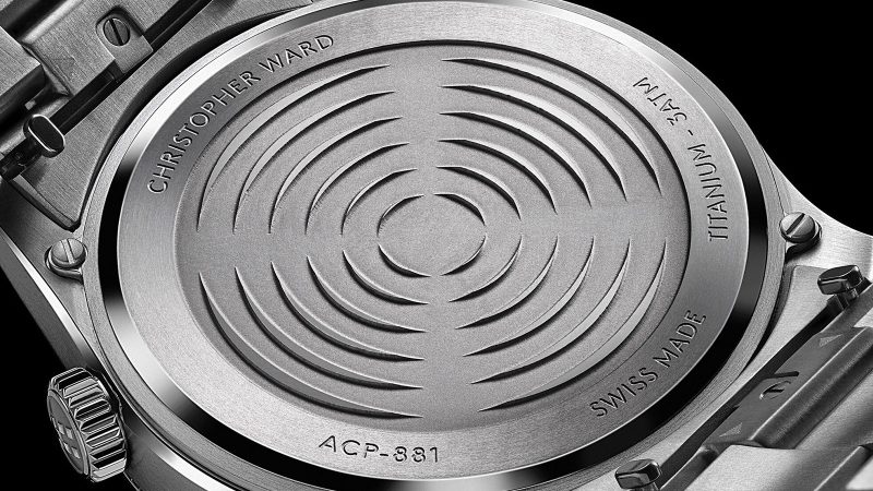 Christopher Ward’s C1 Bel Canto Lumière glowing titanium watch with luminous dial, blue accents, and white Super-LumiNova strap.