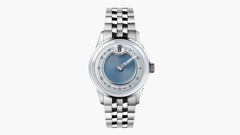 The Christopher Ward C1 Jump Hour Mk V watch with a glowing sapphire dial ring and jump hour display in Noon Blue.