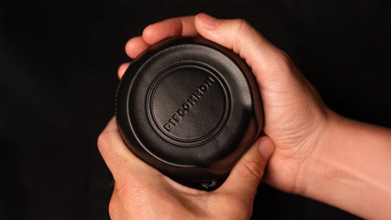 Discommon Goods The Puck watch case in wet-formed Napa leather, shown open and closed, highlighting its sculpted exterior and padded microfiber interior.