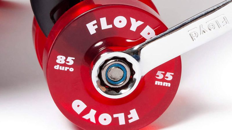 The Floyd Compact Carry-On retro-inspired polycarbonate hard-shell suitcase with skateboard wheels, bold color design, and organized interior travel compartments.