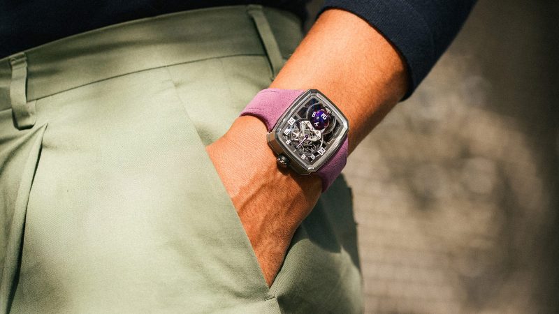 The Hautlence Sphere Series 3 titanium watch with purple spherical jumping hour complication and retrograde minutes on a suede strap.
