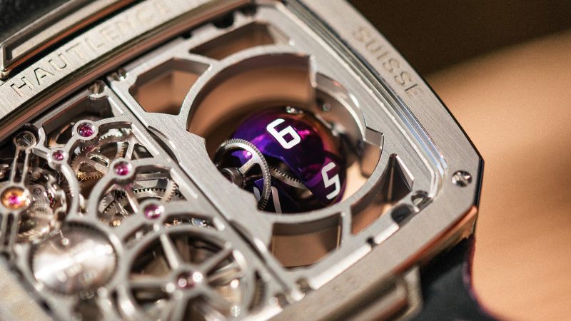 The Hautlence Sphere Series 3 titanium watch with purple spherical jumping hour complication and retrograde minutes on a suede strap.