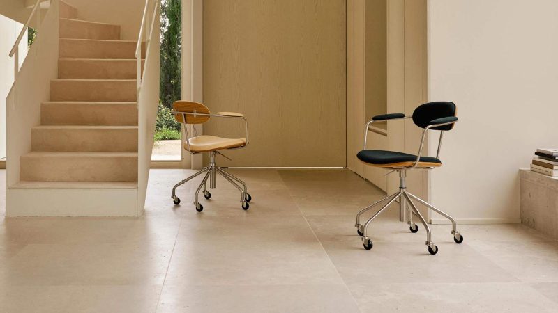 The Hans J. Wegner Swivel Chair, sculpted in wood and leather, showcases mid-century Danish design craftsmanship and ergonomic modern seating.