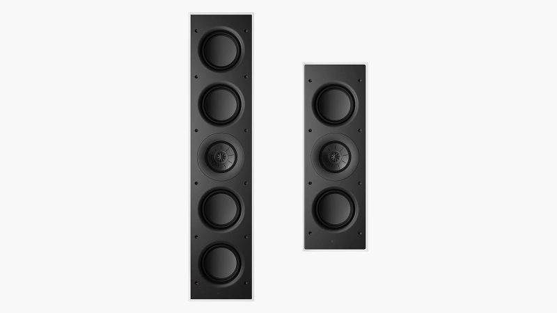 A sleek in-wall KEF architectural speaker mounted flush in drywall, showing the ultra-thin bezel and paintable grille blending with modern interior.
